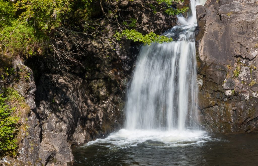 Famous Witch's Cauldron waterfall at the shore of Loch Arkaig, close to Fort William