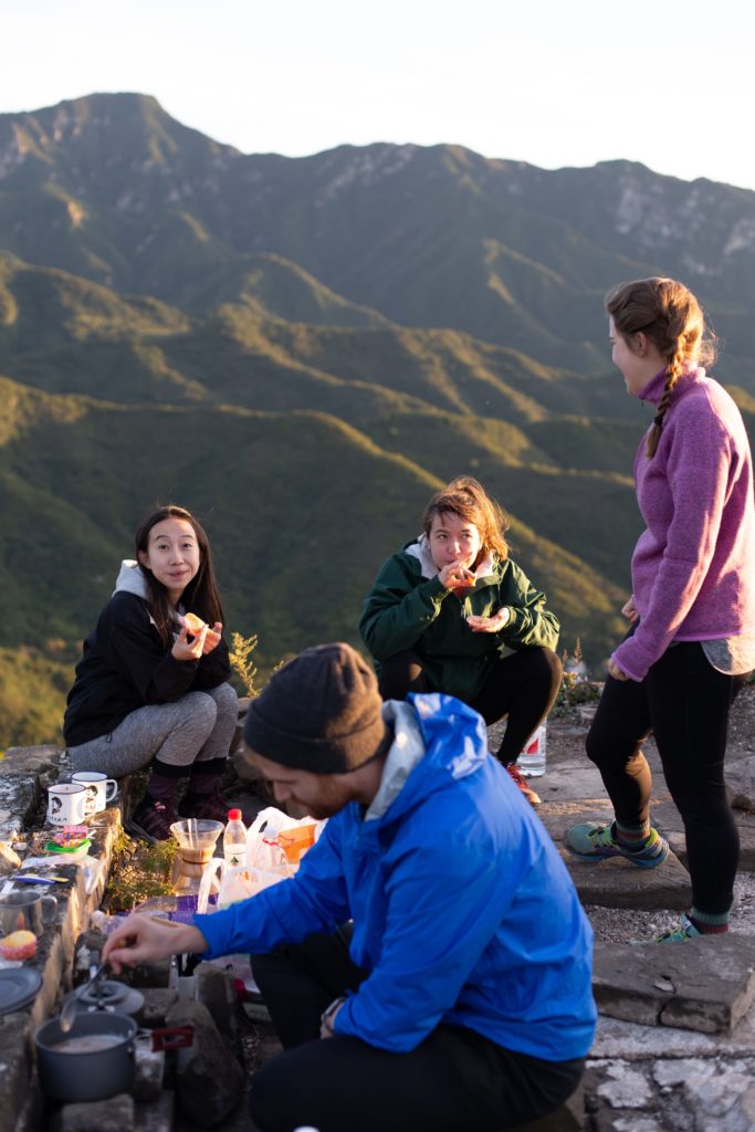 Three women eating on a hike