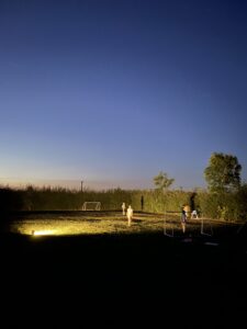 kids playing football at night at Lincolnshire Lanes campsite